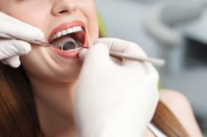 A smiling woman getting a dental exam