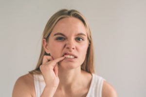 Woman feeling sore gums